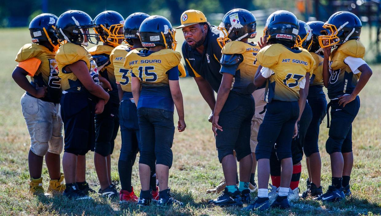 Indy Steelers coach Richard 'Coach Nell' Hamilton huddles with his team on Saturday, Sept. 22, 2019.