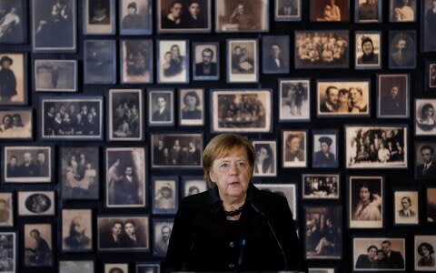 German Chancellor Angela Merkel speaks in the building of the so-called "Sauna" during her visit visit at the former Nazi German concentration and extermination camp Auschwitz-Birkenau near Oswiecim, Poland, December 6, 2019. REUTERS/Kacper Pempel - Credit: KACPER PEMPEL/REUTERS