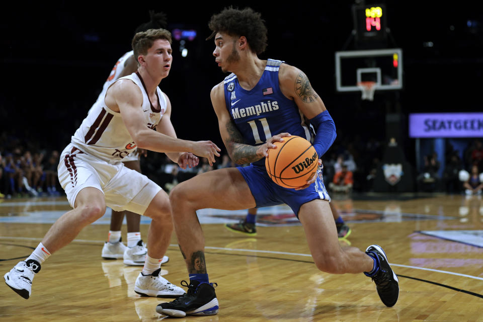 Memphis' Lester Quinones (11) drives past Virginia Tech's Storm Murphy during the first half of an NCAA college basketball game in the NIT Season Tip-Off tournament Wednesday, Nov. 24, 2021, in New York. (AP Photo/Adam Hunger)