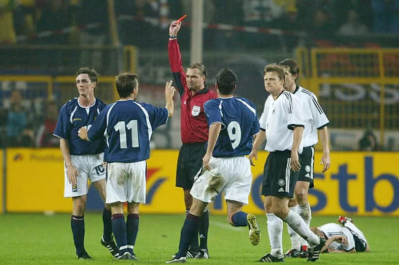 Maurice Ross is shown a red card in their 2003 defeat in Dortmund