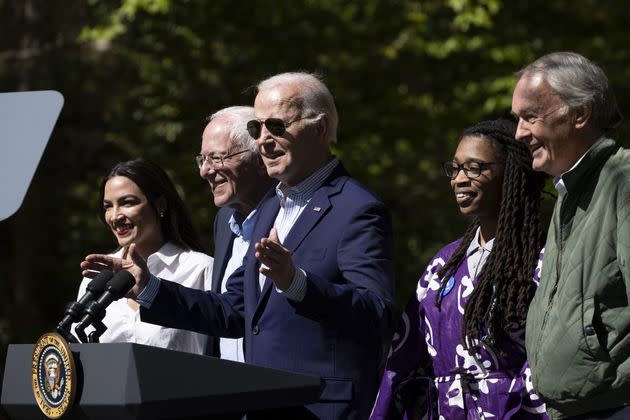 President Joe Biden, center, speaks at an Earth Day event in Virginia as, from left, Rep. Alexandria Ocasio-Cortez (D-N.Y.), Sen. Bernie Sanders (I-Vt.), activist Za'Nyia Kelly and Sen. Ed Markey (D-Mass.) look on.