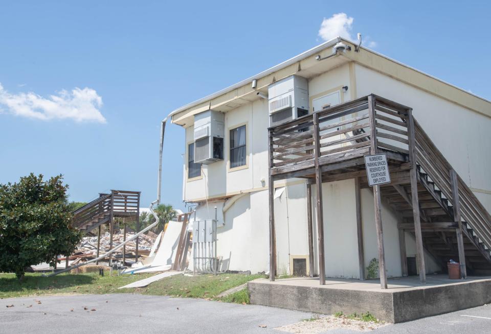 A crew from Virginia Wrecking demolishes the structures behind the old Santa Rosa County Court House in Milton on Friday, Aug. 18, 2023.