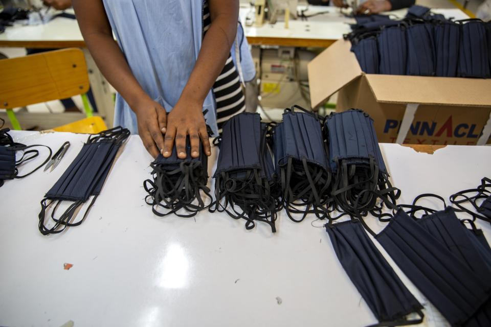 A factory worker counts face masks at the Sonapi Industrial Park in Port-au-Prince, Haiti. (Photo: Dieu Nalio Chery/Associated Press)