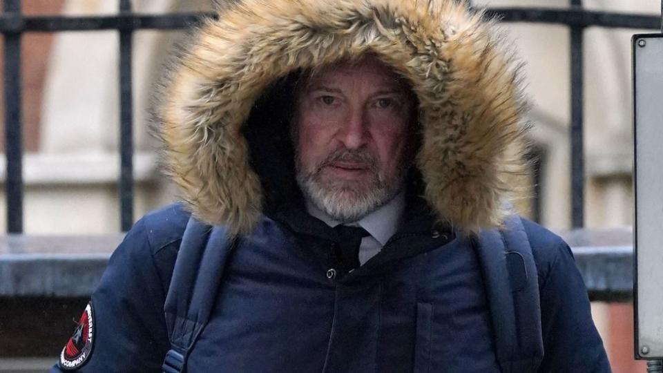 Michael Lousada wearing a furry hood and leaving the Royal Courts of Justice in London