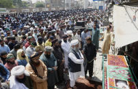 Supporters of Tehreek-e-Labiak Pakistan, a banned Islamist party, offer the funeral prayer of their colleague, who was killed in the Sunday's clash with police, in Lahore, Pakistan, Monday, April 19, 2021. The outlawed Pakistani Islamist political group freed 11 policemen almost a day after taking them hostage in the eastern city of Lahore amid violent clashes with security forces, the country's interior minister said Monday. (AP Photo/K.M. Chaudary)