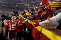 Kansas City Chiefs quarterback Patrick Mahomes (15) celebrates with fans after an NFL divisional round football game against the Buffalo Bills, Sunday, Jan. 23, 2022, in Kansas City, Mo. The Chiefs won 42-36 in overtime. (AP Photo/Charlie Riedel)