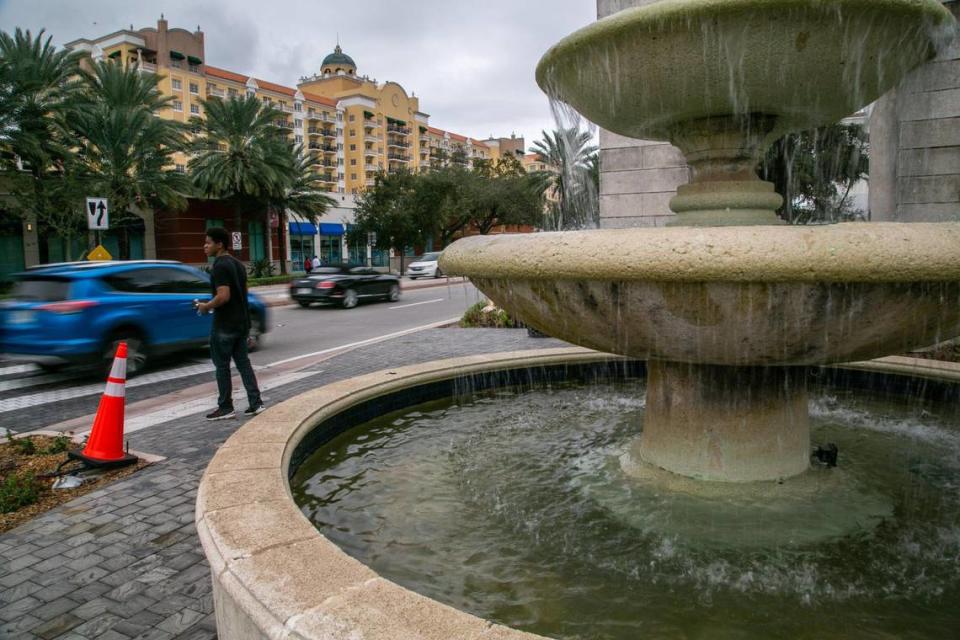 Coral Gables, Florida, Nov. 25, 2020: A pedestrian waits for traffic to pass before crossing at the corner of Southwest 37th Avenue and Miracle Mile.