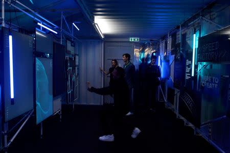 Guests test out body scanning technology, at the launch of Adidas' new shoe line, made in a factory largely operated by robots, in London, Britain October 19, 2017. REUTERS/Mary Turner