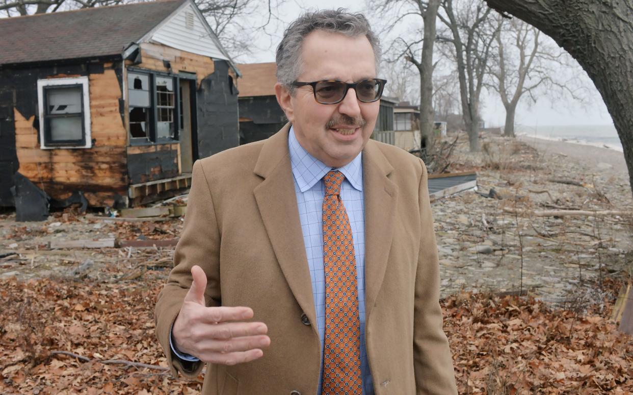 In North East Township, attorney Guy Fustine describes the bankruptcy sale of the former Dohler Cottages, left, during a visit to the property now being developed as Edgewater, with home sites overlooking Lake Erie, back right. Fustine is trustee in the Chapter 11 bankruptcy case.