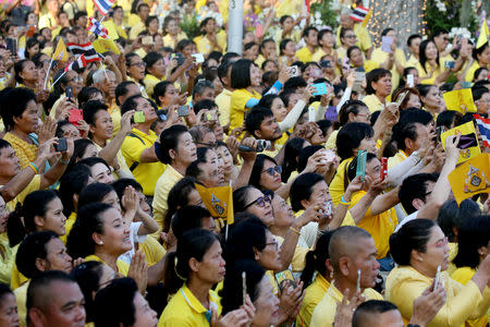 People watch the coronation procession for Thailand's newly crowned King Maha Vajiralongkorn in Bangkok, Thailand May 5, 2019. REUTERS/Athit Perawongmetha