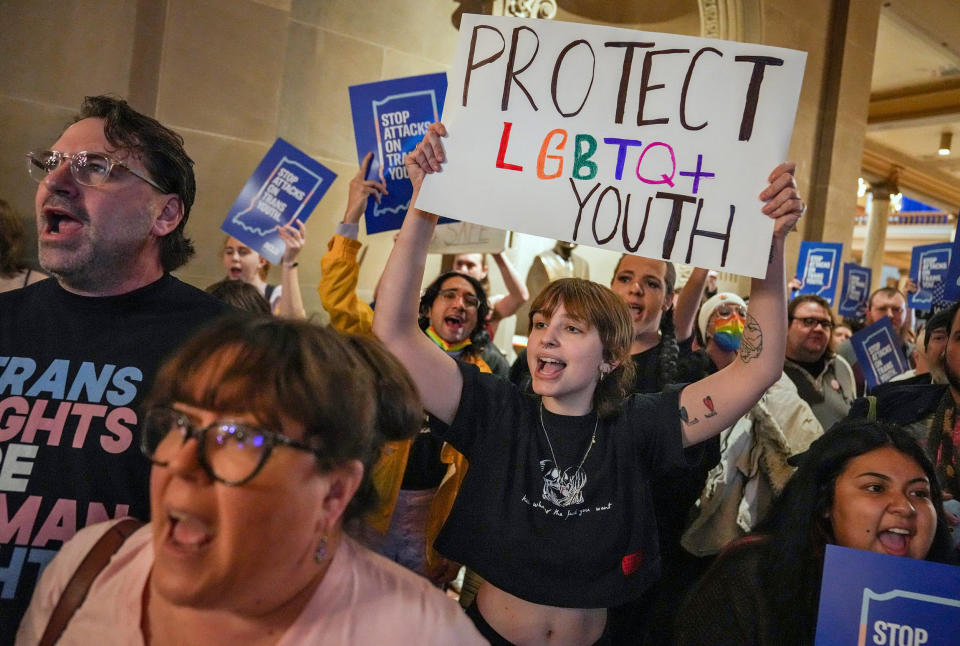 Eliza Housman, center, and others protest outside the Indiana Senate Chamber on Feb. 22, 2023, against a bill which would ban gender-affirming medical or surgical treatment for minors. (Jenna Watson / IndyStar / USA Today Network)