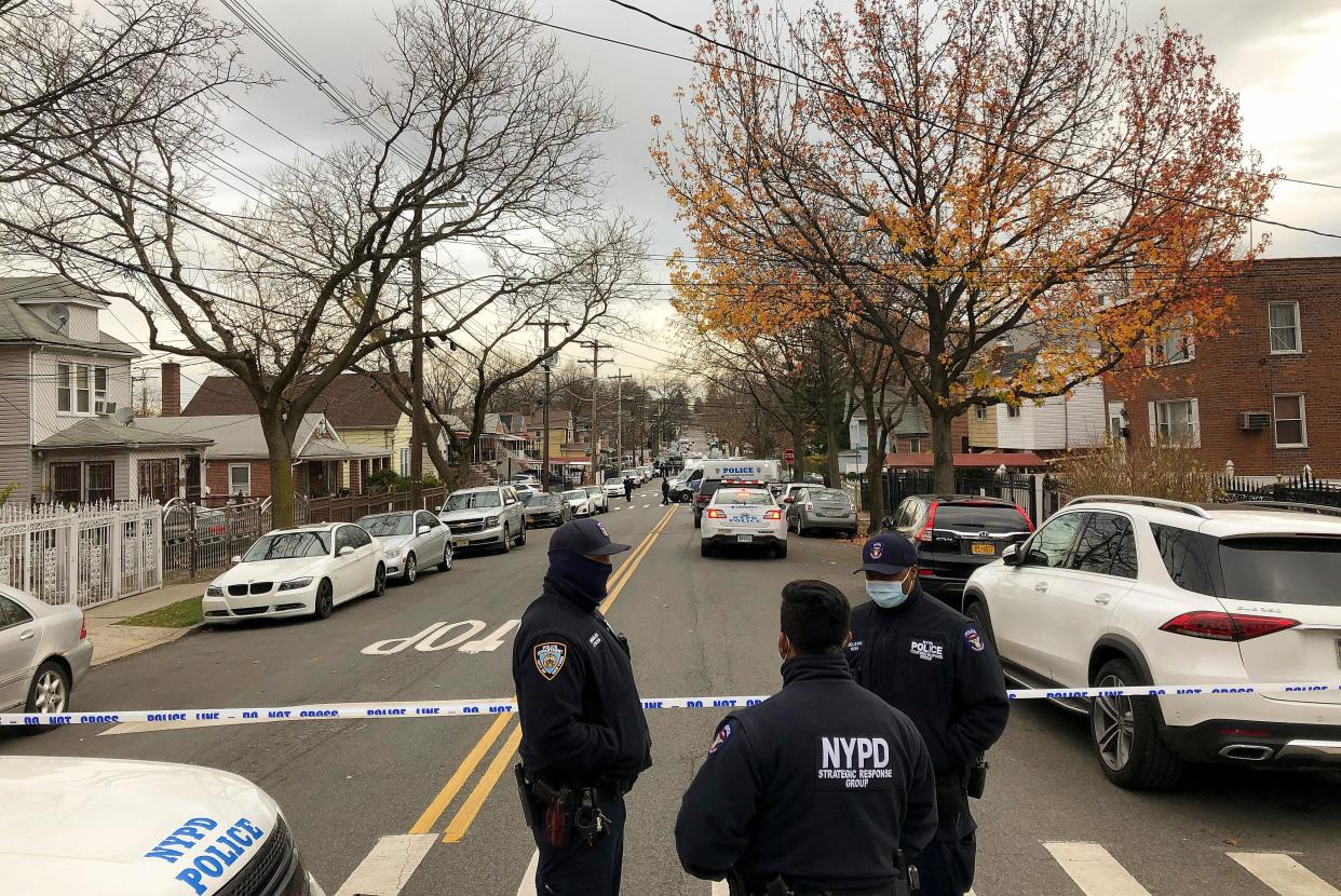 New York Police officers block off the street near the scene where a suspect was killed during a shootout with U.S. marshals in the Bronx that left two officers wounded, Friday, Dec. 4, 2020, in New York. The suspect, 35-year-old Andre Sterling, was wanted for shooting a Massachusetts state trooper in the hand on Nov. 20 during a traffic stop in Hyannis, Mass.