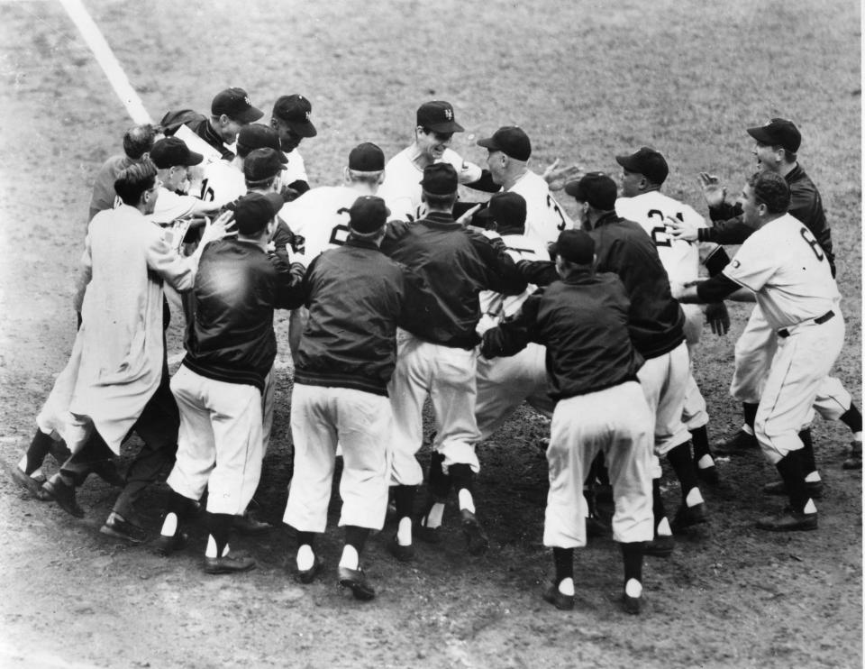 Teammates mob Thomson at home plate. (Mark Rucker/Transcendental Graphics via Getty Images)