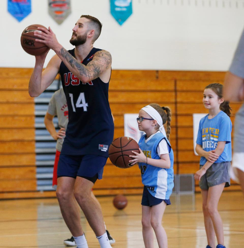 Tyler Lydon takes a jump shot alongside, from  left,  Gracyn and Maddie Clements during the Tyler Lydon Basketball Camp at Stissing Mountain High School on August 8, 2019. 