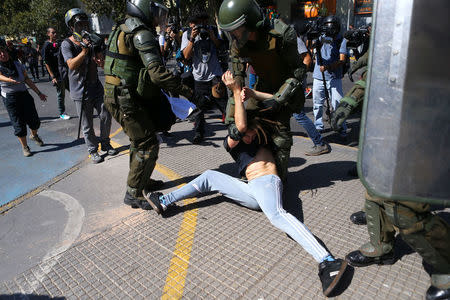 A demonstrator is detained by riot policemen during a protest calling for changes in the education system in Santiago, Chile April 11, 2017. REUTERS/Ivan Alvarado