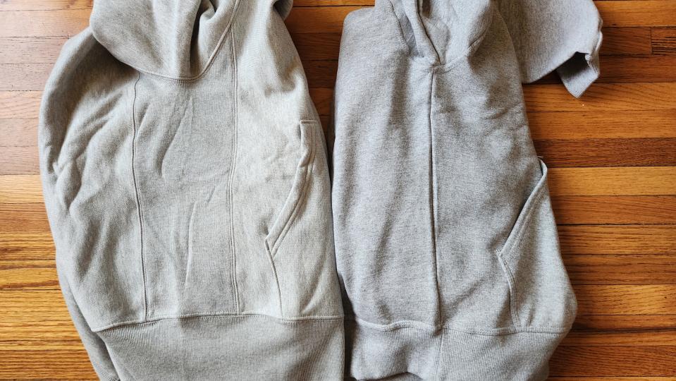 the sleeves of two champion hoodies side by side on a wood floor