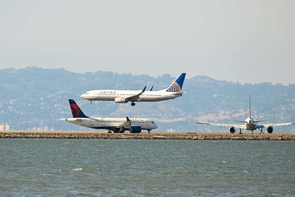 A United and Delta plane at an airport.