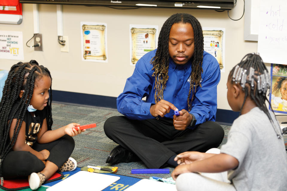 Teacher Ja'Quan Evans with students. (Courtesy Men of CHS Teach)