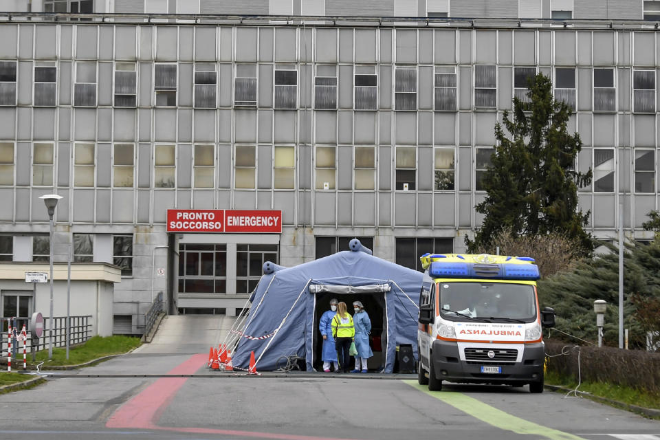 Paramedics stand by a tent that was set up outside the emergency ward of the Cremona hospital, northern Italy, Saturday, Feb. 29, 2020. A U.S. government advisory urging Americans to reconsider travel to Italy due to the spread of a new virus is the “final blow” to the nation's tourism industry, the head of Italy's hotel federation said Saturday. (Claudio Furlan/Lapresse via AP)