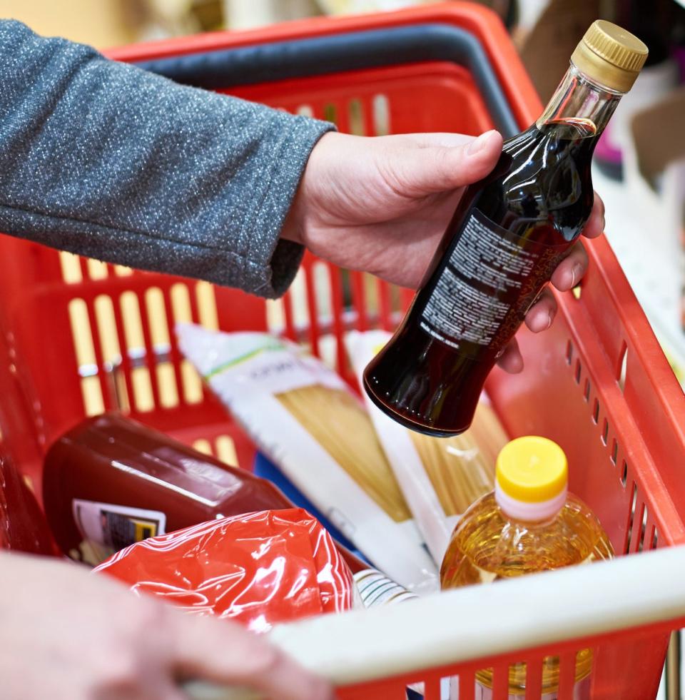 A person shopping for condiments.