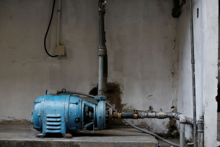 Water pumps are seen at an apartment block in downtown Caracas, Venezuela, March 18, 2019. REUTERS/Carlos Garcia Rawlins