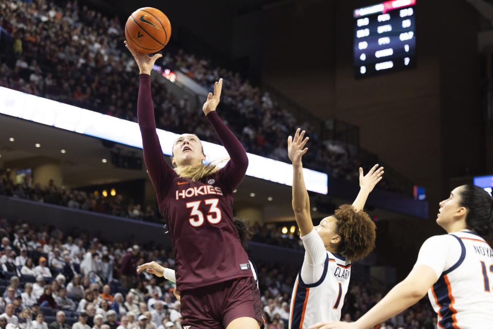 Virginia Tech's Elizabeth Kitley (33) shoots over Virginia's Paris Clark (1) during the first half of an NCAA college basketball game Sunday, March. 3, 2024, in Charlottesville, Va. (AP Photo/Mike Kropf)