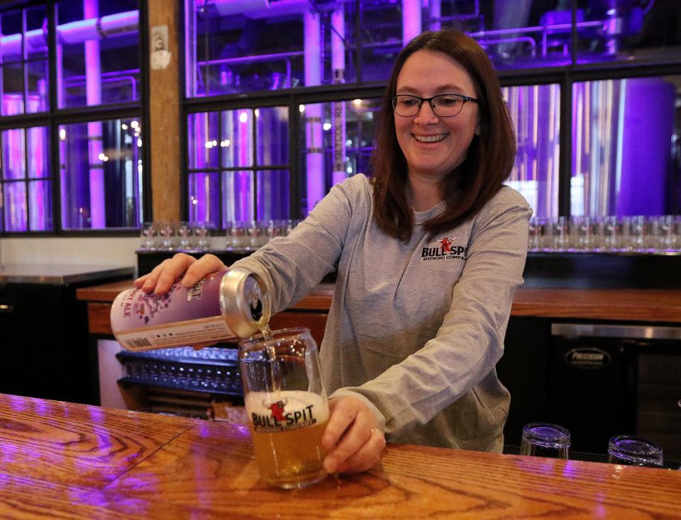 Taproom Supervisor Liz Boutwell pours a glass of ale in the new Taproom at Bull Spit Brewing Company in Maynard, Feb. 8, 2022.