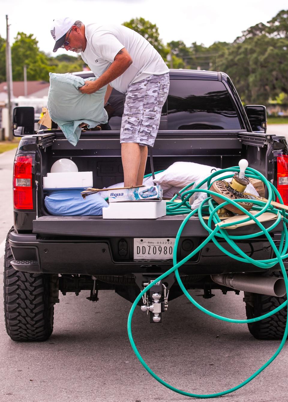 Joey Belle gathers items in separate piles in the bed of his pickup truck while dropping off household garbage and recyclables at the Baseline Recycling Center on May 13.