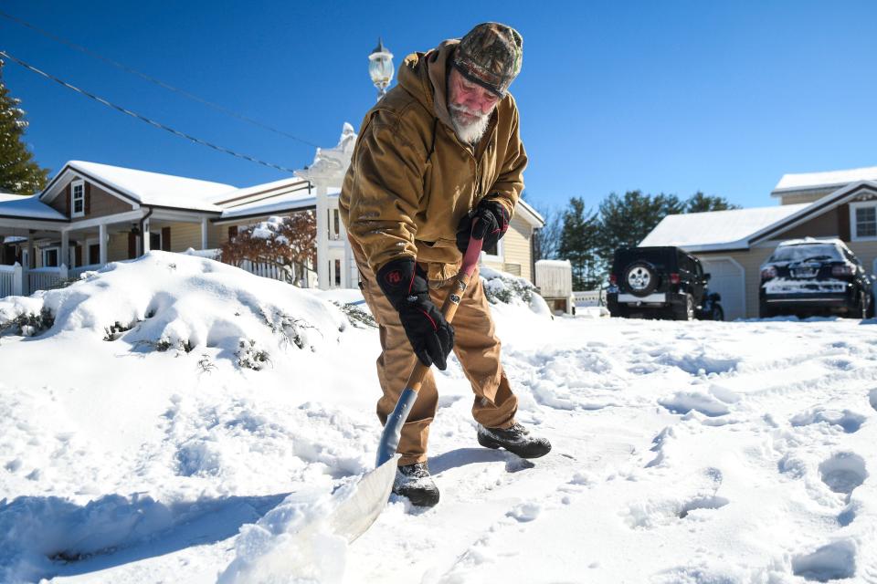 Gary Hobby clears off his driveway on Jan. 17. Knoxville will face single-digit temperatures and negative wind chills on Jan. 19 and 20.