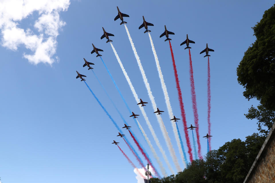 French Alpha jets of the Patrouille de France and the UK Royal red arrows aerobatic planes spraying lines of smoke in the colors of the French flag fly over the Mont-Valerien, a memorial for the French who fought against the Nazis and those who were killed by the occupying forces, in Suresnes, west of Paris, Thursday, June 18, 2020 at the start of the traditional annual ceremony of commemoration for the 80th anniversary of Charles de Gaulle's radio appeal to his countrymen to resist Nazi occupation during WWII. French President Emmanuel Macron is traveling to London to mark the day that De Gaulle delivered his defiant broadcast 80 years ago urging his nation to fight on despite the fall of France. In a reflection of the importance of the event, the trip marks Macron's first international trip since France's lockdown amid the COVID-19 pandemic. (Ludovic Marin/Pool via AP)