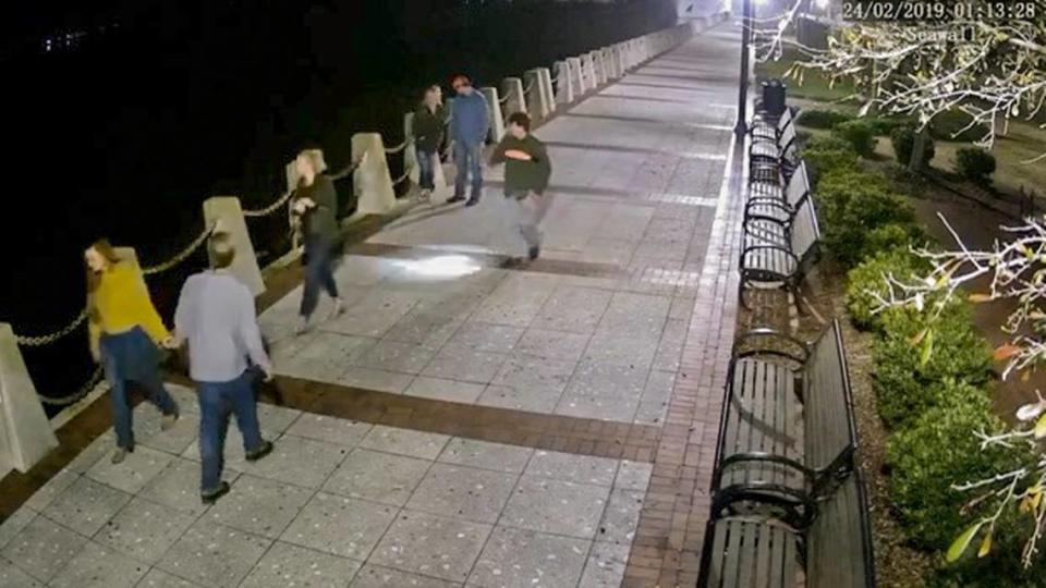 Paul Terry Murdaugh uses a flashlight to see his father’s boat at the Beaufort Day Dock in this video surveillance still at 1:13 a.m. on Feb. 24, 2019 at Henry C. Chambers Waterfront Park. Mallory Beach, who died later that morning in the boating accident, is seen at back talking with her boyfriend.