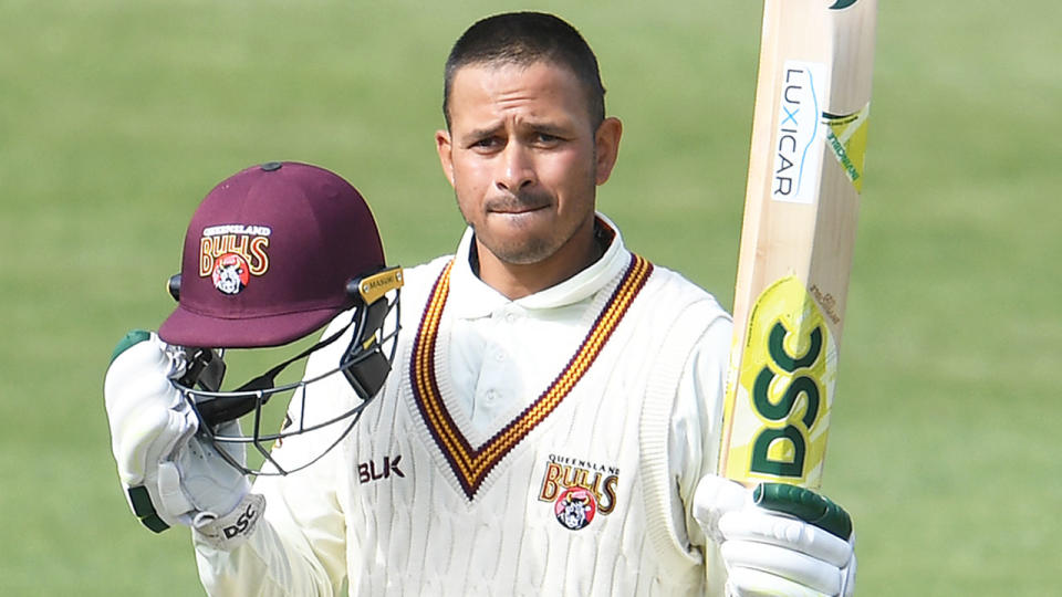 Usman Khawaja is seen celebrating a century for QLD in the Sheffield Shield.