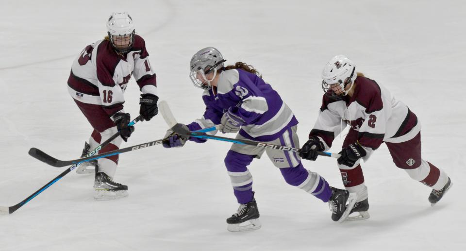 FALMOUTH -- 02/08/23 -- Falmouth's Katherine Shanahan, left, and Avery Johnsen look to block a first period play by Martha's Vineyard's Maia Donnelly.