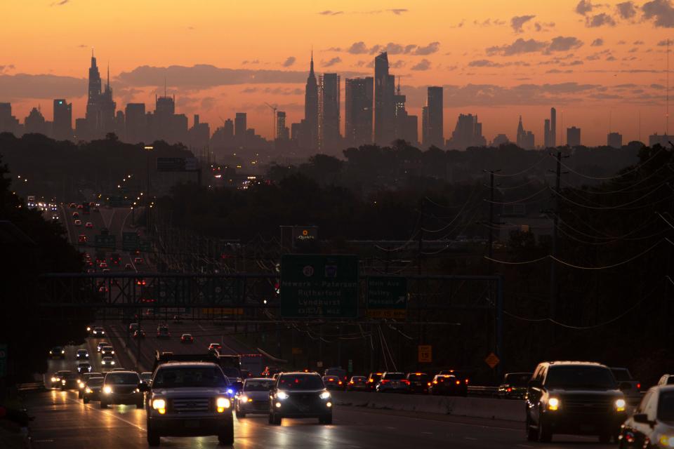 The sunrise over the New York City skyline and Route 3 in Clifton, N.J.