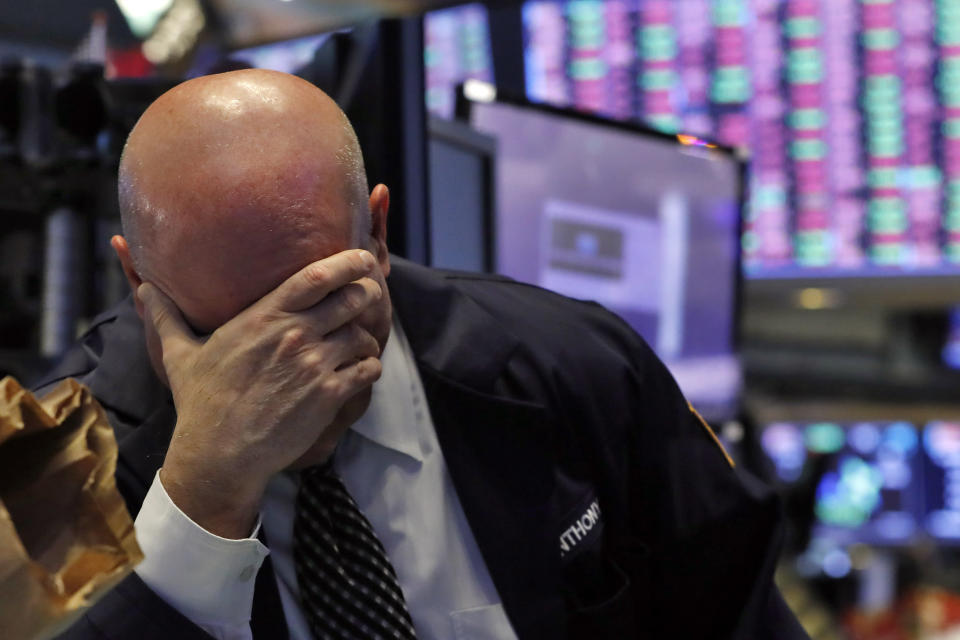 A trader has his head in his hand on the floor of the New York Stock Exchange, Thursday, March 12, 2020. The stock market had its biggest drop since the Black Monday crash of 1987 as fears of economic fallout from the coronavirus crisis deepened. The Dow industrials plunged more than 2,300 points, or 10%. The vast majority of people recover from the new coronavirus. According to the World Health Organization, most people recover in about two to six weeks, depending on the severity of the illness. (AP Photo/Richard Drew)