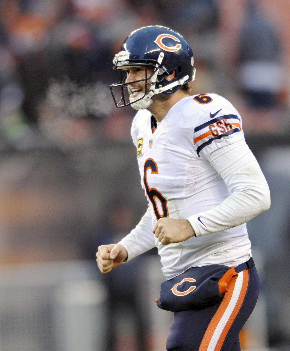 FILE - In this Dec. 15, 2013 file photo, Chicago Bears quarterback Jay Cutler celebrates a touchdown by Bears running back Michael Bush in the fourth quarter of an NFL football game against the Cleveland Browns, in Cleveland. The Bears have signed Cutler to a seven-year contract. The move was announced Thursday, Jan. 2, 2014, and it came after some speculation that the Bears might part with Cutler after five years. (AP Photo/David Richard, File)