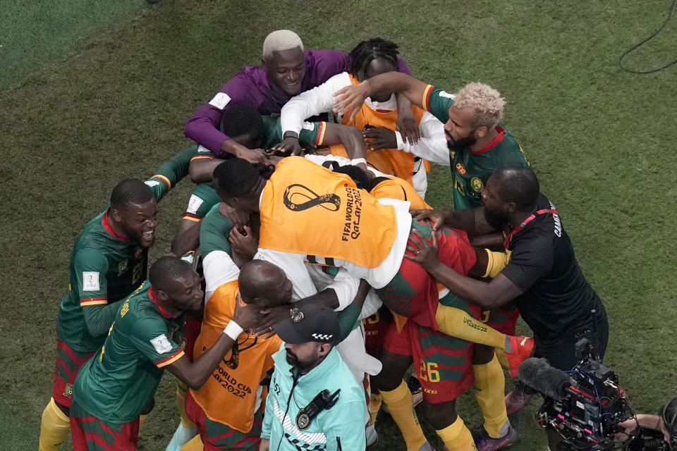 Cameroon players celebrate after scoring the opening goal during the World Cup group G soccer match between Cameroon and Brazil, at the Lusail Stadium in Lusail, Qatar, Friday, Dec. 2, 2022. (AP Photo/Thanassis Stavrakis)