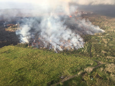 An aerial view shows an active lava flow crossing Pohoiki Road during ongoing eruptions of the Kilauea Volcano in Hawaii, U.S. May 28, 2018. Picture taken May 28. 2018. USGS/Handout via REUTERS