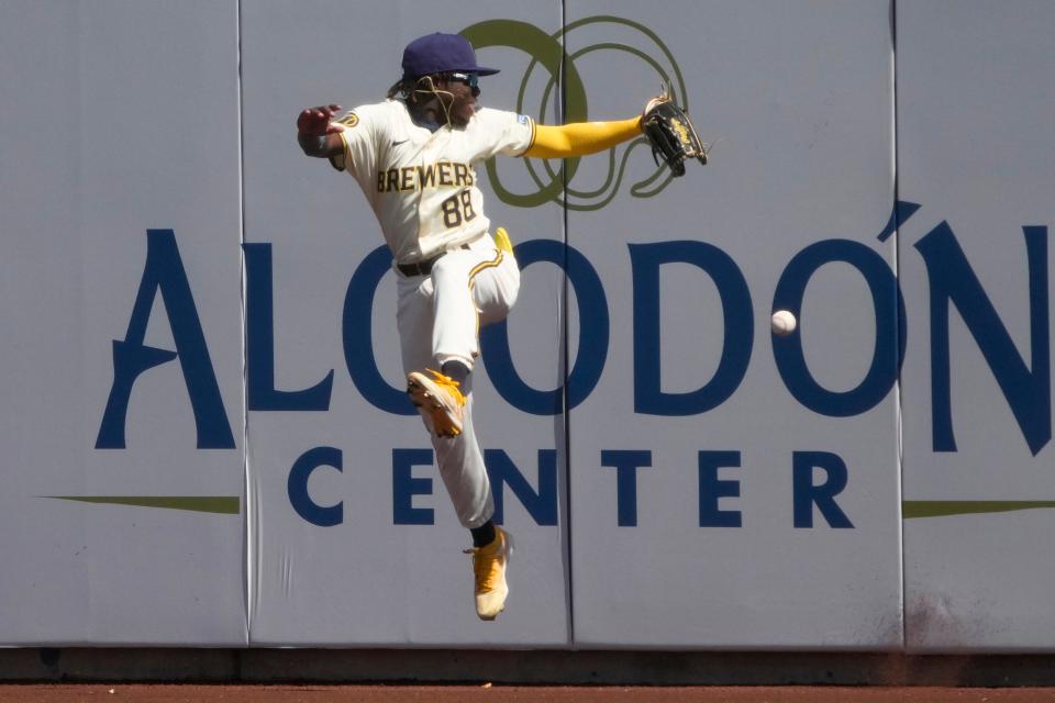 Brewers right fielder Luis Lara jumps for the ball Wednesday in the first inning of an exhibition game against the White Sox in Phoenix.