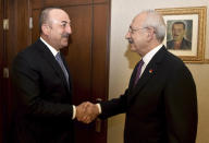 Turkey's Foreign Minister Mevlut Cavusoglu, left, and Kemal Kilicdaroglu, the leader of the main opposition Republican People's Party, CHP, shake hands before a meeting, in Ankara, Turkey, Monday, Dec. 30, 2019. The CHP said Monday it does not support the government's plans to deploy troops to Libya, saying the move would embroil Turkey in another conflict and make it a party to the "shedding of Muslims." (AP Photo)