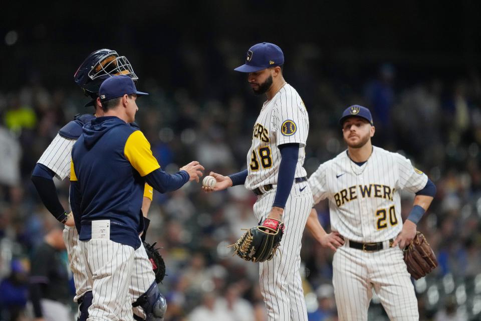 Brewers closer Devin Williams hands the ball to manager Craig Counsell as he is removed from the game against the Marlins on Saturday night.