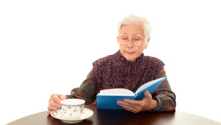 old woman reading her book