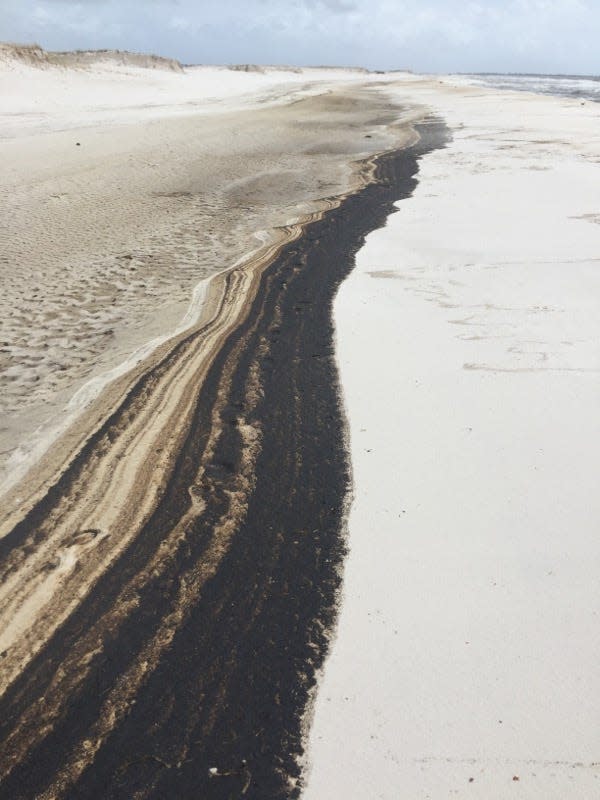 Oil washes up along Johnson Beach on Perdido Key on Saturday.