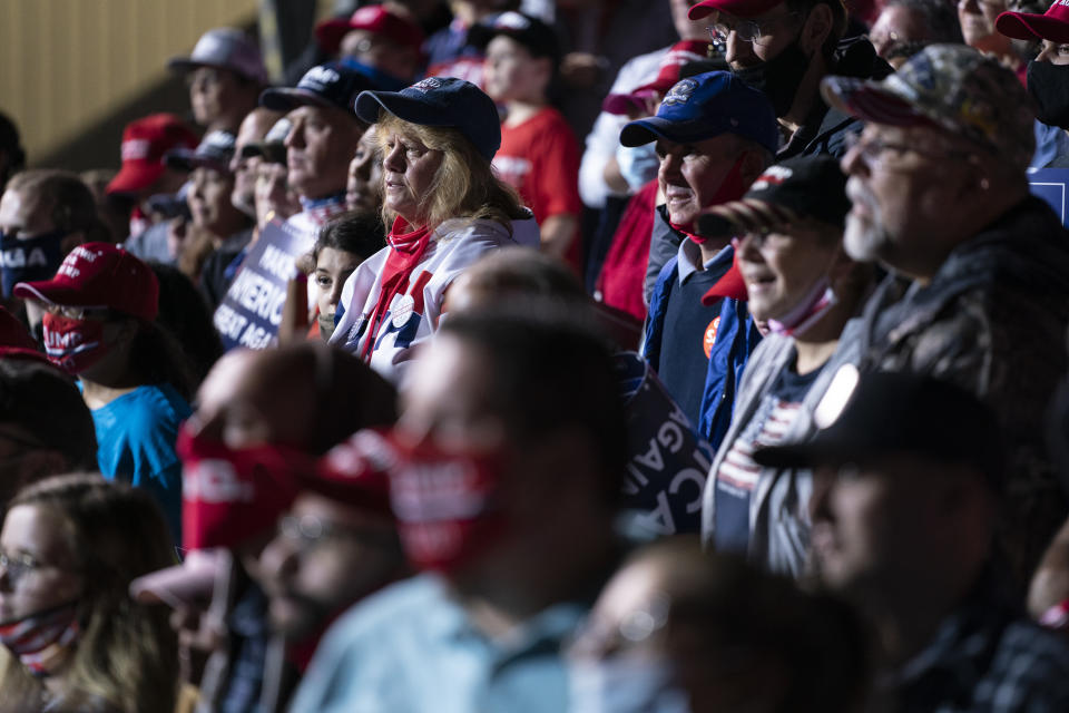 Supporters of President Donald Trump listen as he speaks at a campaign rally, Friday, Sept. 25, 2020, in Newport News, Va. (AP Photo/Evan Vucci)