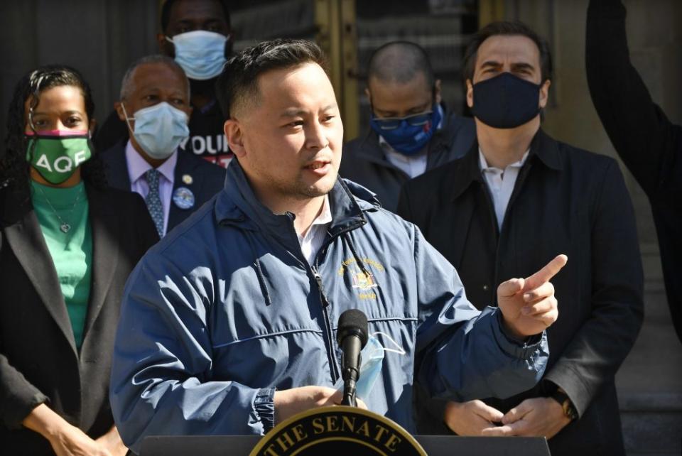 New York Assemblyman Ron Kim at a news conference, announcing new revenue plans by ending tax breaks for the rich, standing next to Democratic lawmakers Hans Pennink