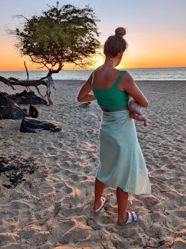 "This photo is of me and my daughter when she was about 5 months old," the author writes. "We had finally overcome breastfeeding challenges, and now I was able to feed her just about anywhere — even on the beach!" <span class="copyright">Courtesy of Ella Rachel Kerr</span>