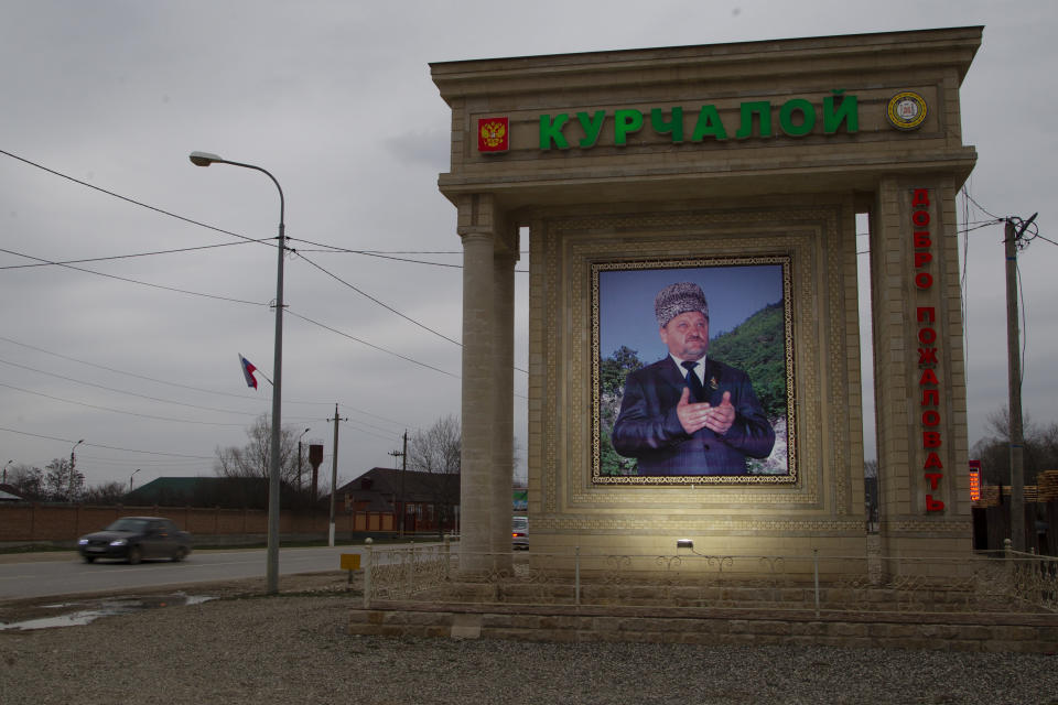 In this Sunday, March 17, 2019, photo, a memorial tomb of the late Chechen President Akhmat Kadyrov, who was killed in a rebel bombing, is seen at the entrance of Kurchaloy, Chechnya, Russia. A court in Russia's Chechnya is due to issue its verdict Monday, March 18 in the case of prominent rights activist Oyub Titiyev. (AP Photo/Musa Sadulayev)