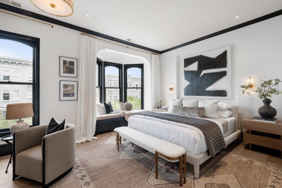 Principal bedroom of the iconic home. The walls are painted largely white or light gray, with most rooms punctuated with splashes of color on door frames, the fireplace mantle, and cabinets (Lunghi Studio)