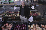 John Gold, self-employed graphics designer, poses at a farmer's market outside his office in Portland, Maine, Wednesday, Oct. 23, 2019. Gold has been covered by the Affordable Care Act since it started, plans on shopping for plans for 2020 again when the enrollment season starts Nov. 1. The 2020 sign-up season for the Affordable Care Act is getting underway with premiums down slightly in many states and more health plan choices for consumers. (AP Photo/Charles Krupa)