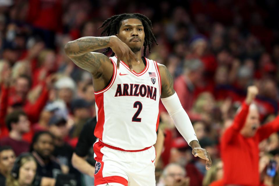 Arizona guard Caleb Love (2) makes a 3-pointer against Arizona State and then celebrates with the Wildcats bench by signaling a forks down during the first half at McKale Center.